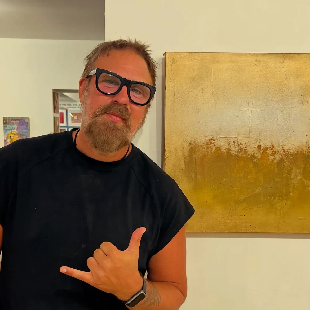 Brad Byrd beside his gold painting Autumn at a Hi-Desert Artists opening reception