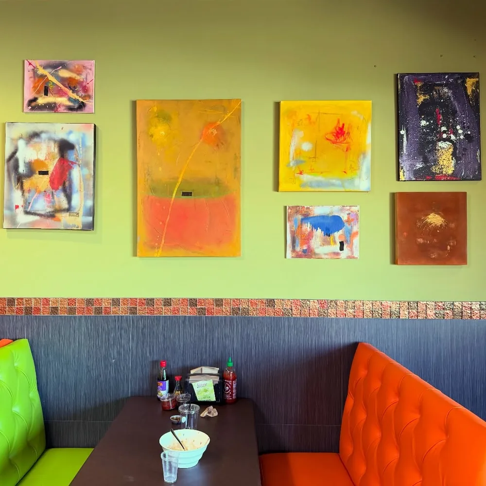 Seven abstract paintings by Brad Byrd hung on the wall of 29 Yum Lounge